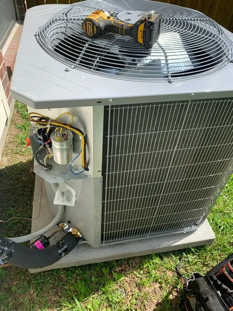 Technician repairing a residential air conditioning system
