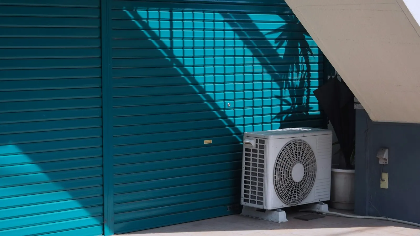 Outdoor AC condenser beside a residential building