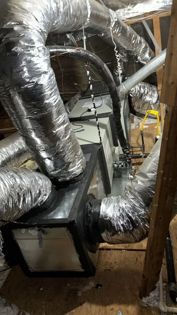 New ductwork being installed in a residential attic